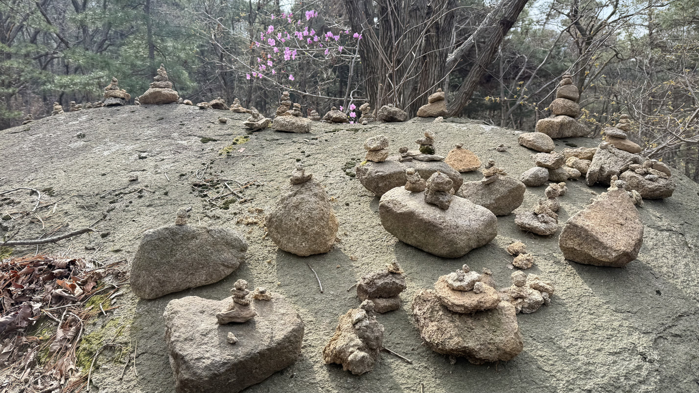 Stone carins built on a large rock [WOO JI-WON]