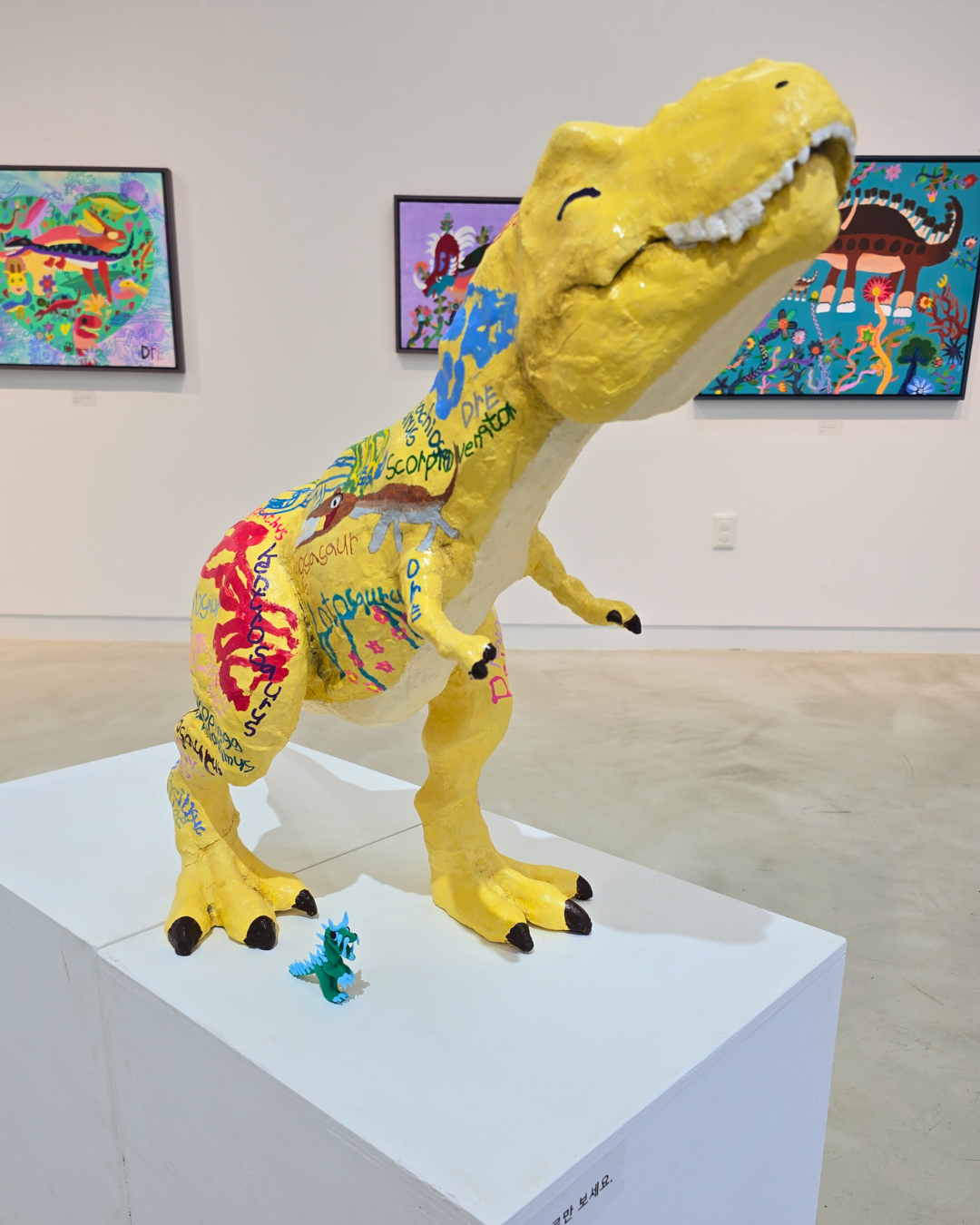 Artist An Dre's dinosaur sculpture and paintings on display at an exhibition [AN DRE'S FAMILY]