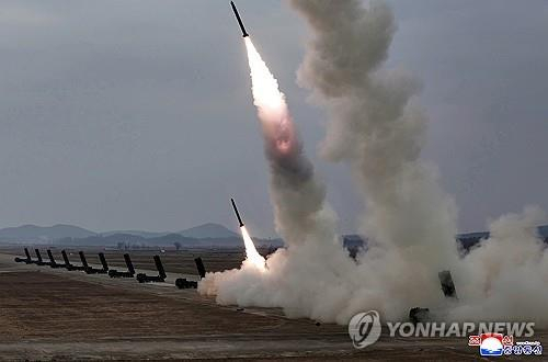 North Korea carries out a firepower strike drill involving 600-millimeter ultraprecision multiple rocket launchers on March 14 in this photo published by the Korean Central News Agency the following day. [YONHAP]