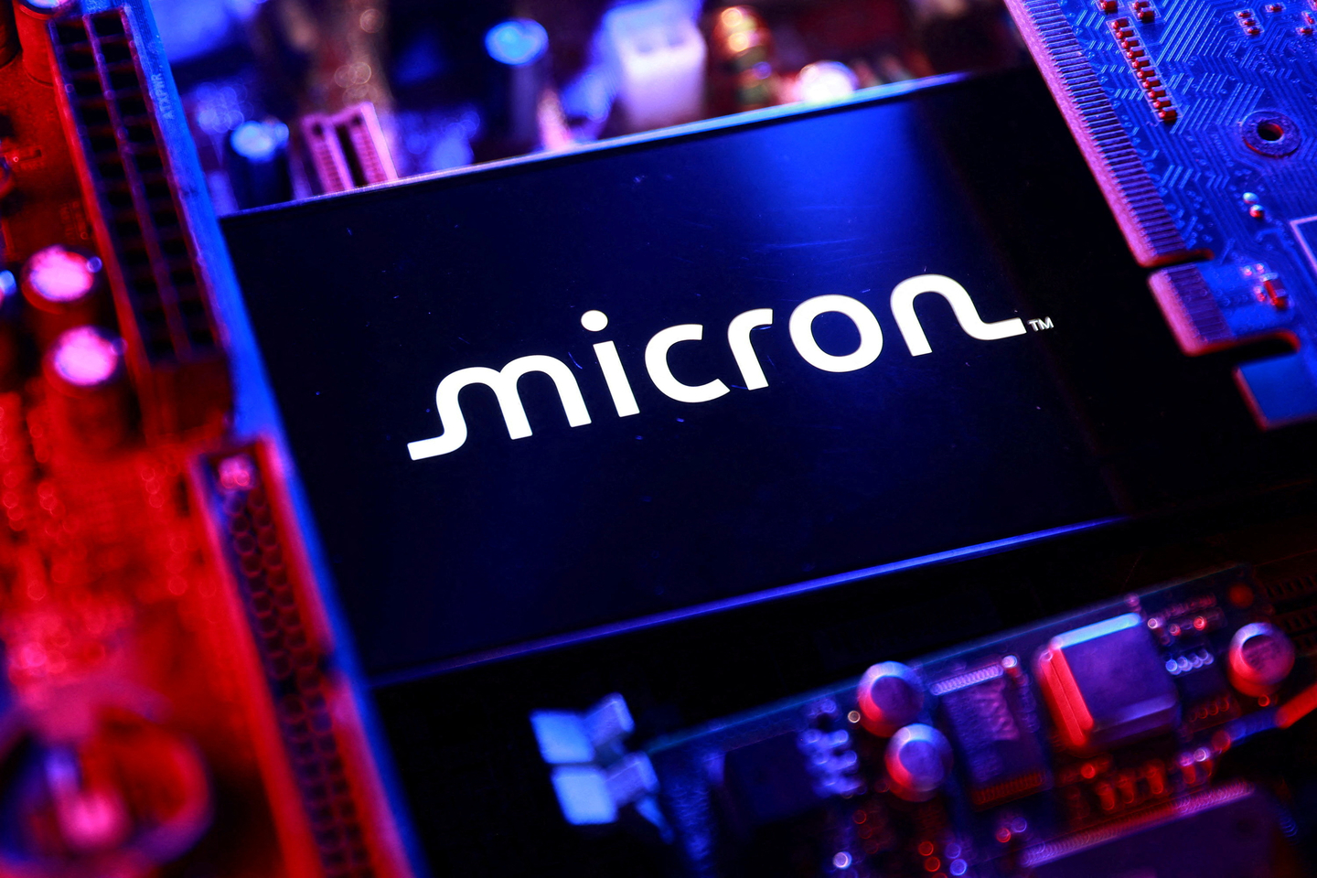 A Micron logo and a computer motherboard appear in this illustration created on August 25, 2025. [REUTERS/YONHAP]