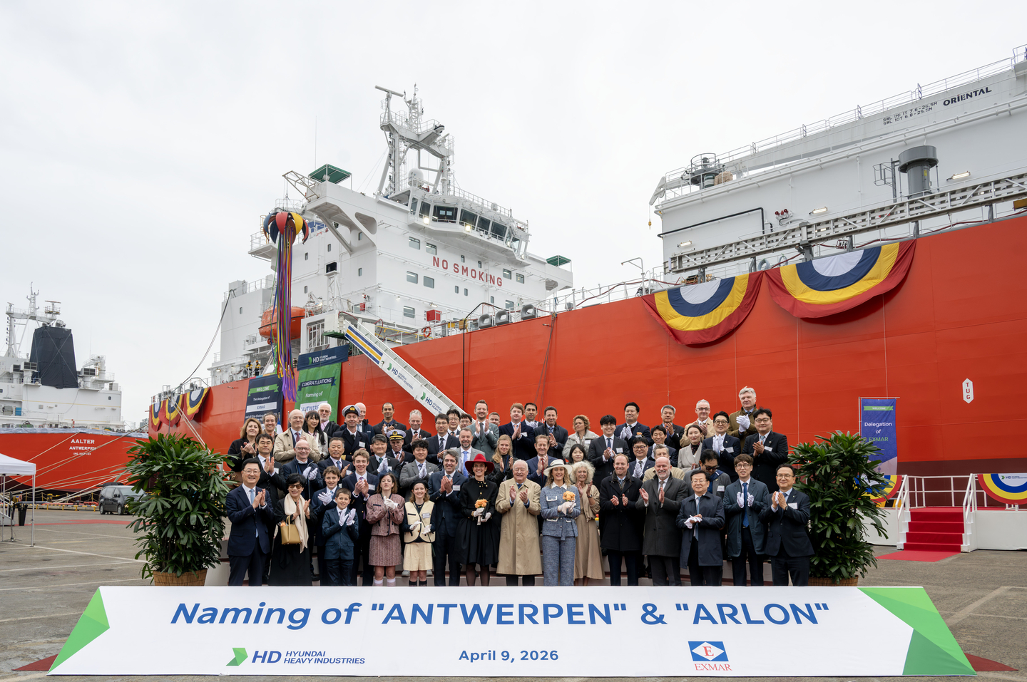 Attendees pose for a commemorative photo at the naming ceremony for ammonia-powered carriers held on April 9 at HD Hyundai Heavy Industries’ Ulsan shipyard. From front row, far left, Joo Won-ho, president of naval & medium size ships business unit at HD Hyundai Heavy Industries; seventh from left, Nicolas Saverys, chairman of Exmar; third from right, H.E. Bruno Jans, ambassador of Belgium to Korea. [HD HYUNDAI HEAVY INDUSTRIES]
