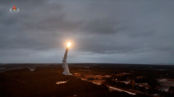 North Korea conducts a test launch of a new high-altitude, long-range surface-to-air missile over the East Sea on Dec. 25, 2025, under the observation of its leader, Kim Jong-un. [YONHAP] 