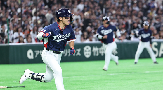 Kim Do-yeong celebrates as he heads to first off a hit that secured an RBI against Australia in Tokyo on March 9. [YONHAP]