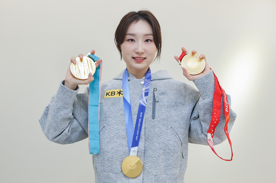 Short track speed skater Choi Min-jeong poses for a photo with her gold medals from the PyeongChang, Beijing and Milan-Cortina Winter Olympics on April 11. [YONHAP]