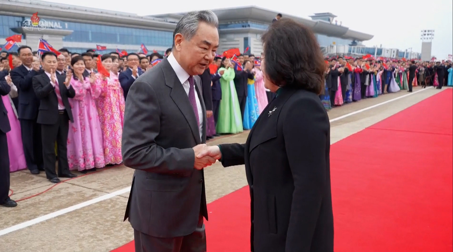 Chinese Foreign Minister Wang Yi shakes hands with North Korean counterpart Choe Sun-hui at an airport in Pyongyang on April 9, in footage carried by Korean Central TV the following day. [YONHAP] 