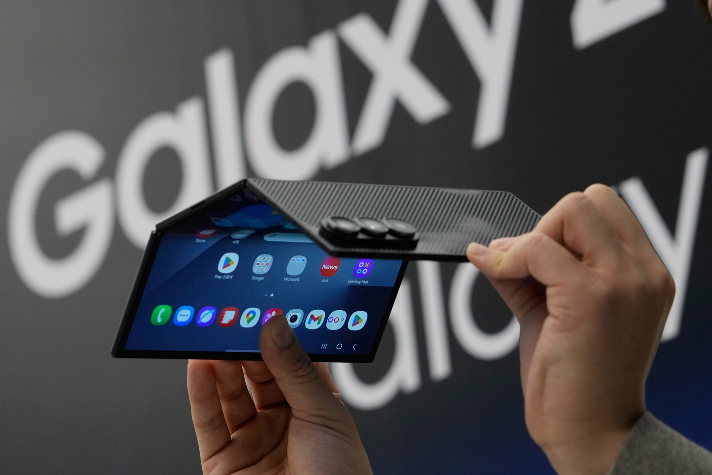 A person holds a Samsung Galaxy Z TriFold smartphone during a launch event at a Samsung store in Seoul on Dec. 2, 2025. [AP PHOTO/YONHAP]