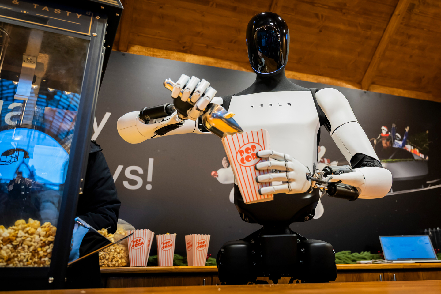 Tesla's humanoid robot 'Optimus' distributes popcorn at a Christmas market stall during its presentation at a mall in Berlin, Germany on Dec. 20, 2025. [AP]
