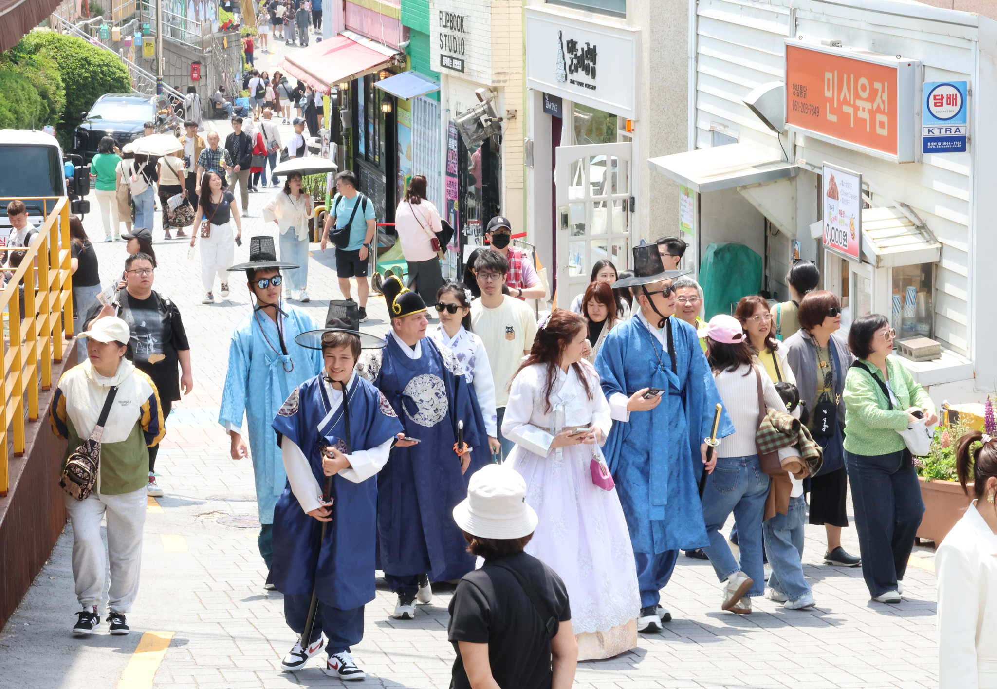 Visitors dressed in "hanbok," or traditional Korean clothing, walk around Gamcheon Culture Village in Busan on May 26, 2025. [YONHAP]