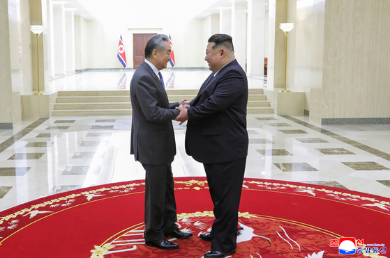 North Korean leader Kim Jong-un, right, meet with Chinese Foreign Minister Wang Yi during his visit to Pyongyang on April 10. [YONHAP]