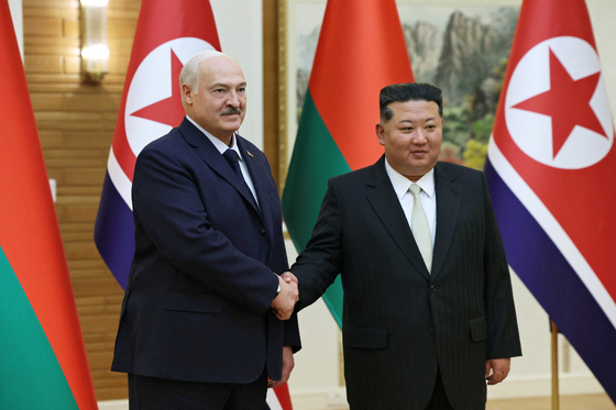 Belarusian President Alexander Lukashenko shakes hands with Kim Jong Un during a meeting in Pyongyang, March 26. PRESIDENT OF THE REPUBLIC OF BELARUS, REUTERS/YONHAP] 