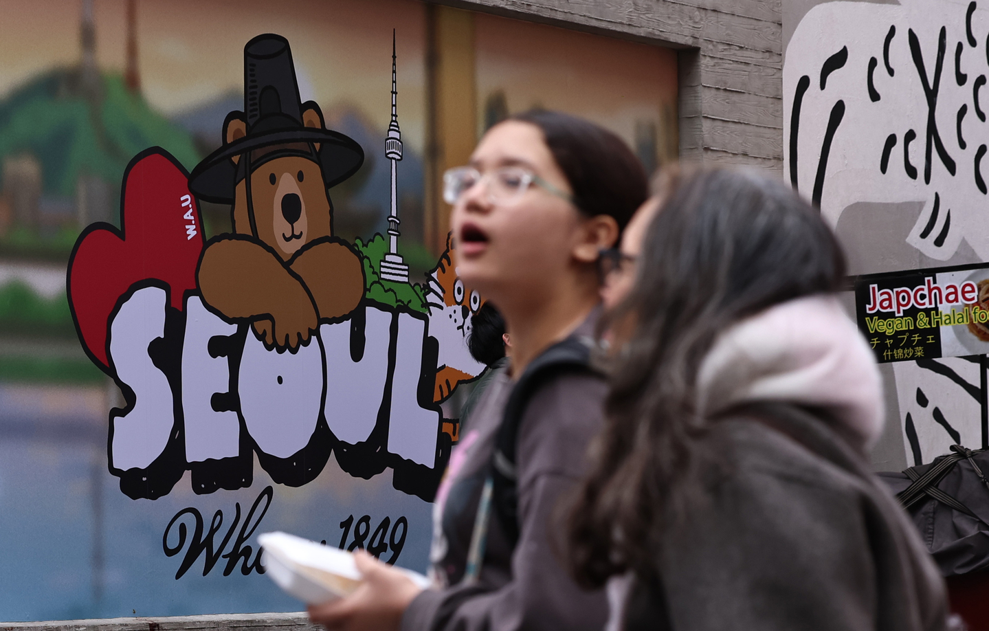 Visitors are seen in the streets of Myeongdong in central Seoul in February. [NEWS1] 