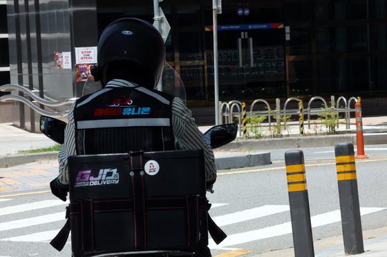 A delivery driver in Gwangju drives his motorbike on July 2, 2025. [YONHAP]