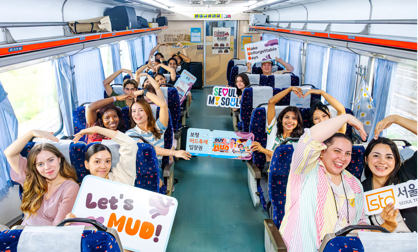 Visitors pose for a photograph while riding a train to South Chungcheong in August 2025. [NEWS1] 