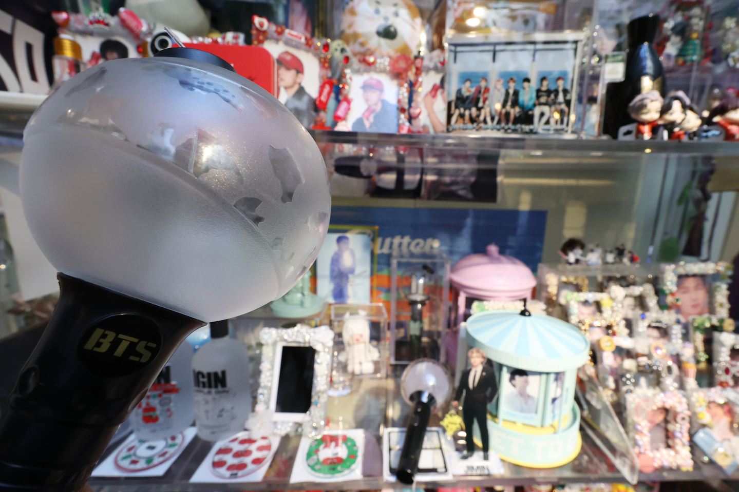 BTS merchandise, including official light sticks, is displayed at a coffee shop in Yongsan District, central Seoul, on March 19. [YONHAP]