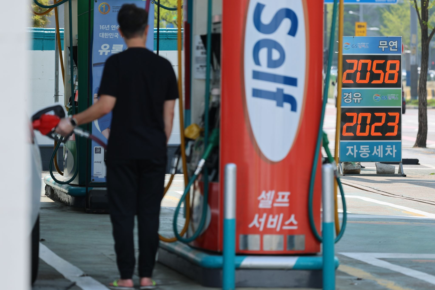 A man loads up his vehicle with fuel at a gas station in Seoul on April 15. [YONHAP]