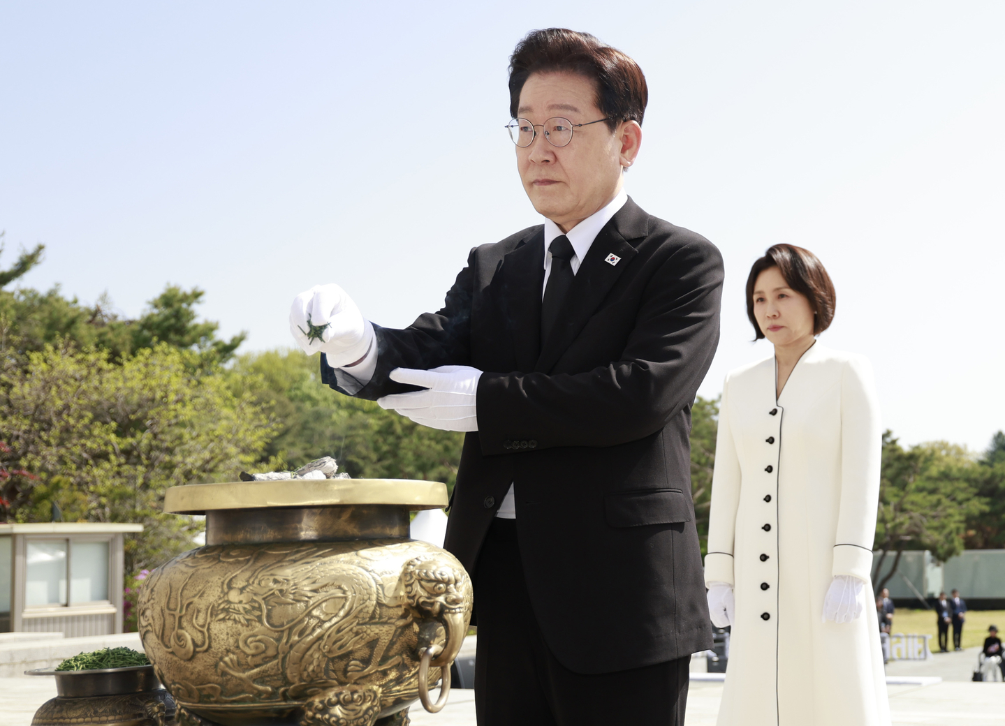 President Lee Jae Myung, left, burns incense at the April 19th National Cemetery in Seoul on April 19 on the 66th anniversary of the 1960 pro-democracy uprising by students that toppled then-President Syngman Rhee. First lady Kim Hea Kyung stands behind Lee. [JOINT PRESS CORPS]