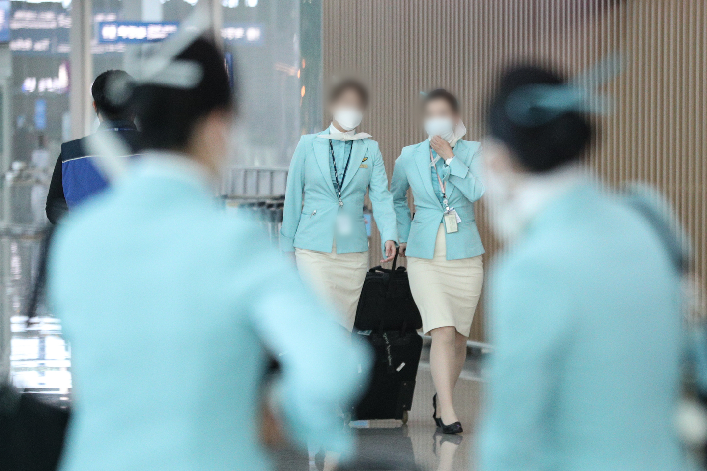 Korean Air flight attendants are seen walking at Incheon International Airport on Feb. 26, 2020. [NEWS1]