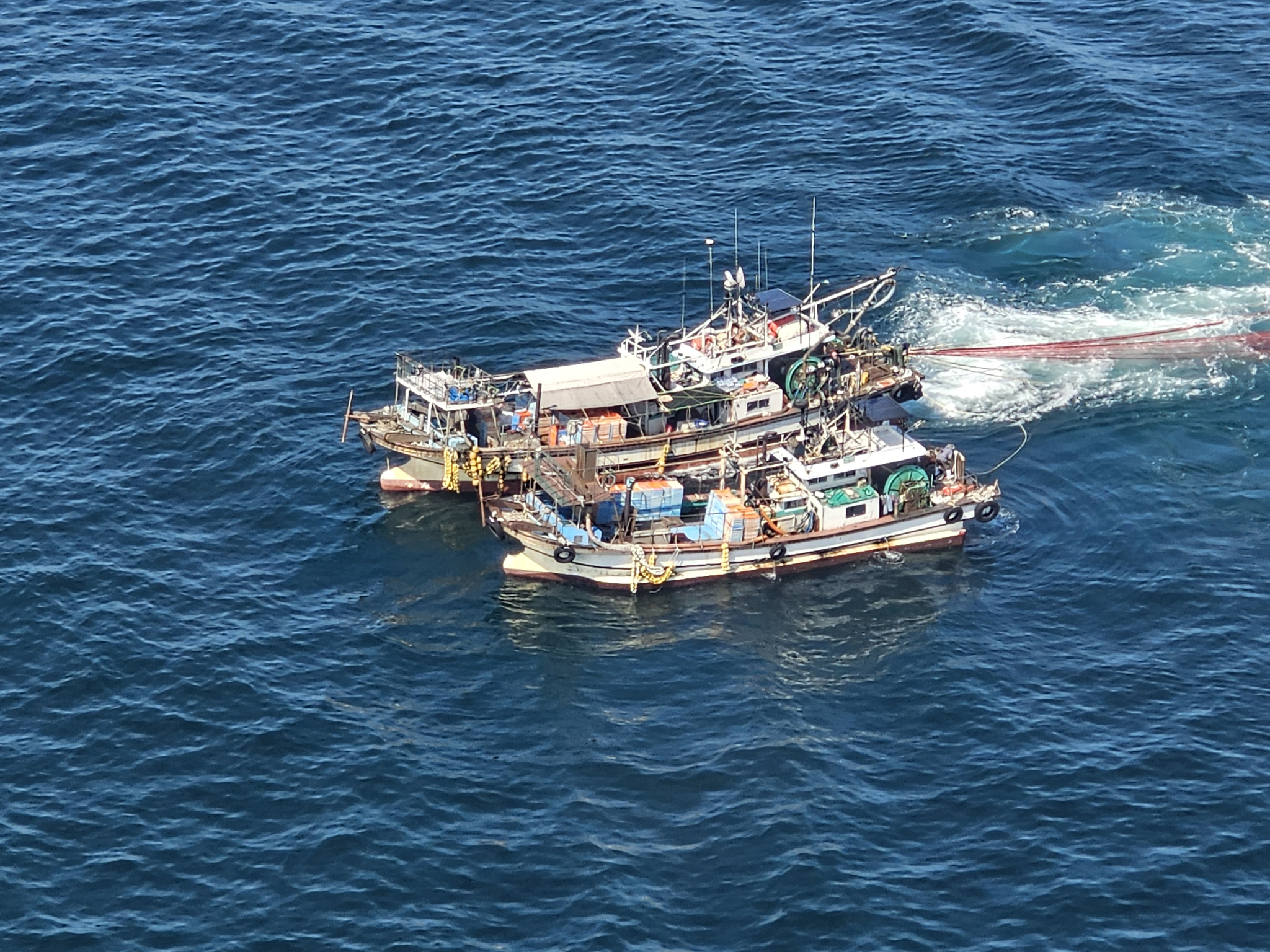 A helicopter from the Yeosu Aviation Unit under the West Sea Regional Coast Guard operates surveillance equipment to film an illegal fishing vessel on Aug. 9, 2024. [NEWS1] 