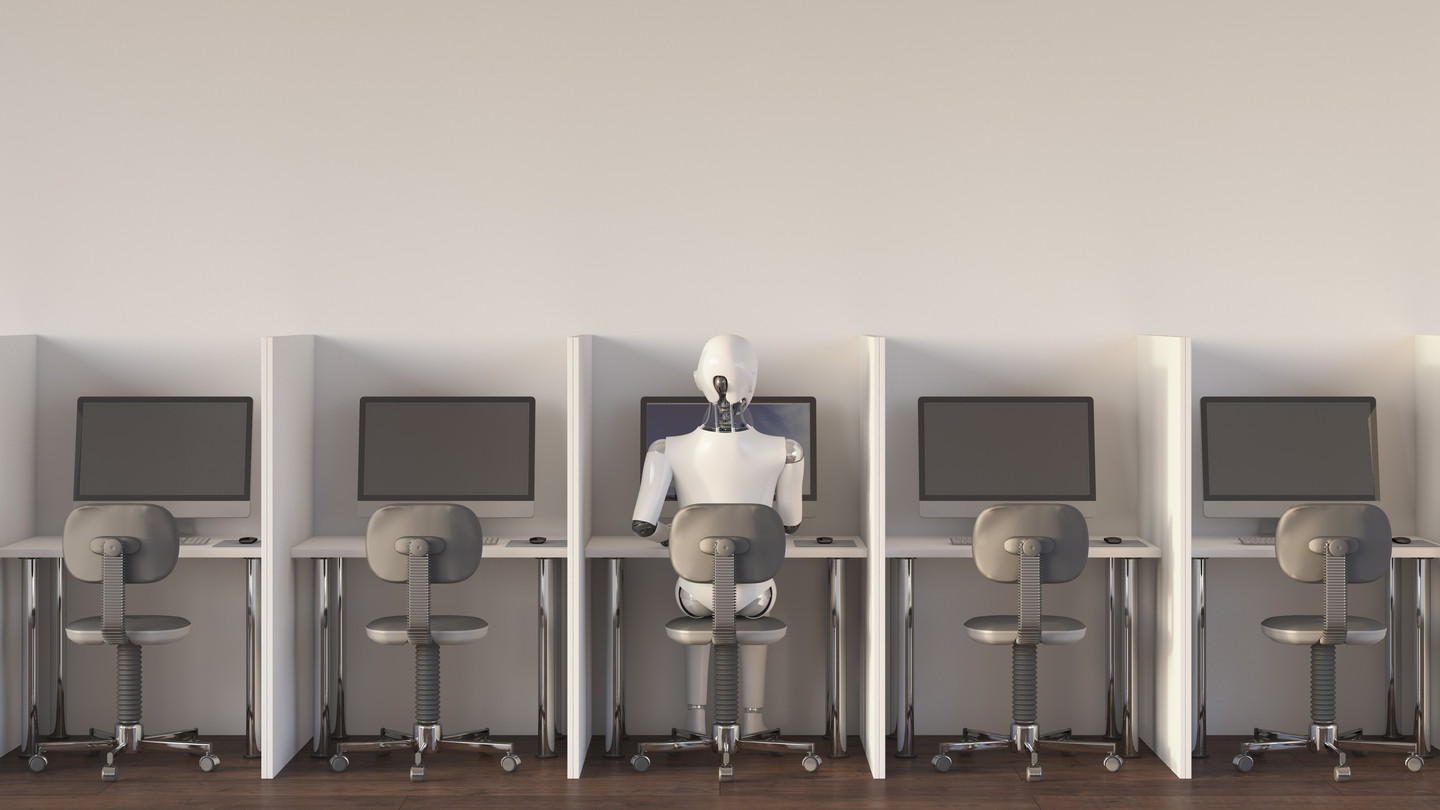 A robot sitting in an office, working alone [GETTY IMAGES]