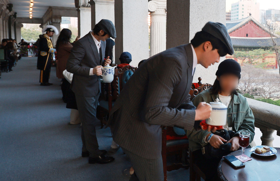 Visitors enjoy refreshments at the second-floor cafe of Seokjojeon, the Western-style building inside Deoksu Palace in Jung District, central Seoul, on April 8. [YONHAP]