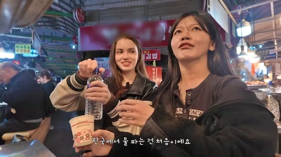 A screen capture from the YouTube channel Khaing shows the YouTuber purchasing a bottle of water for 2,000 won ($1.35). [SCREEN CAPTURE/JOONGANG ILBO]