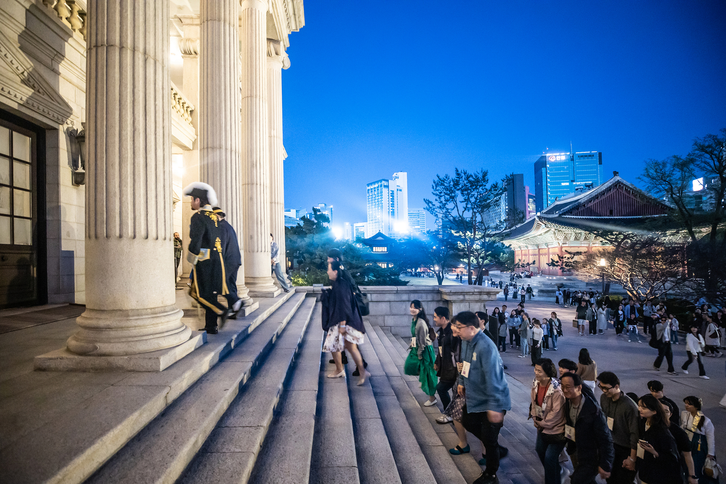 Visitors are guided into Seokjojeon Hall, the Western-style building on the grounds of Deoksu Palace, during a night tour. [KOREA HERITAGE AGENCY]