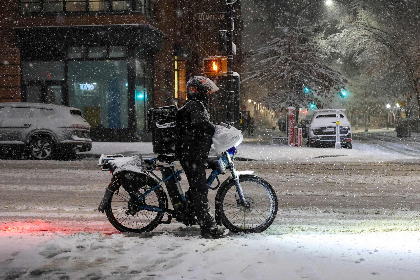 A person on a delivery bike rides through the snow in New York City on Feb. 22. [AFP/YONHAP]