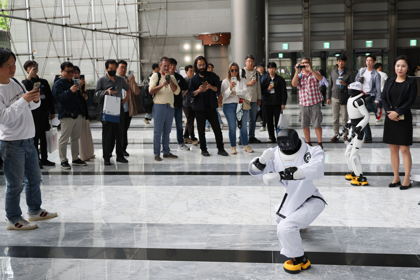 Onlookers watch a robot dancing at the Autonomous Manufacturing AI World Show 2026 held at Coex in Gangnam District, southern Seoul on April 27. [YONHAP]