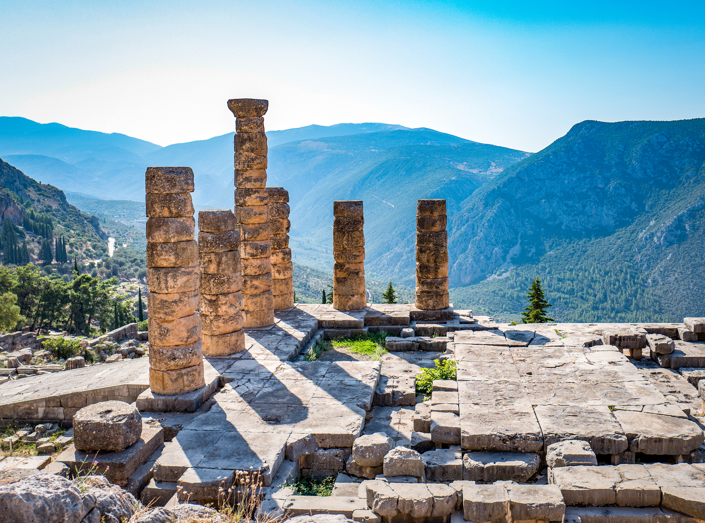 Ruins of the ancient Temple of Apollo at Delphi, overlooking the valley of Phocis. [WIKIPEDIA]