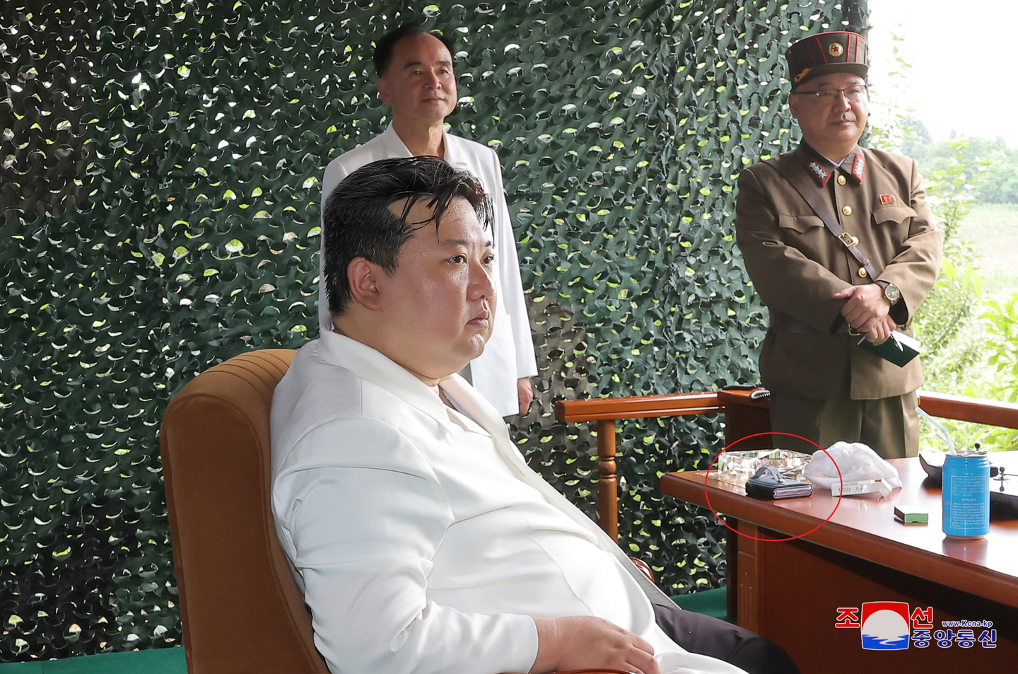 North Korean leader Kim Jong-un oversees a test launch of the new Hwasong-18 solid-fueled intercontinental ballistic missile on July 12, 2023, where an object believed to be a foldable smartphone, shown inside the red circle, was spotted, in this image provided by the Korea Central News Agency. [YONHAP]